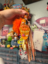 Load image into Gallery viewer, Pua Signature Bag Charm | Tropical Princess Sidekick | Acrylic Charms | Faux Leather Flower | Pom Pom Orange Ocean
