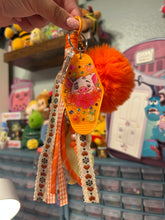 Load image into Gallery viewer, Pua Signature Bag Charm | Tropical Princess Sidekick | Acrylic Charms | Faux Leather Flower | Pom Pom Orange Ocean
