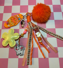 Load image into Gallery viewer, Pua Signature Bag Charm | Tropical Princess Sidekick | Acrylic Charms | Faux Leather Flower | Pom Pom Orange Ocean
